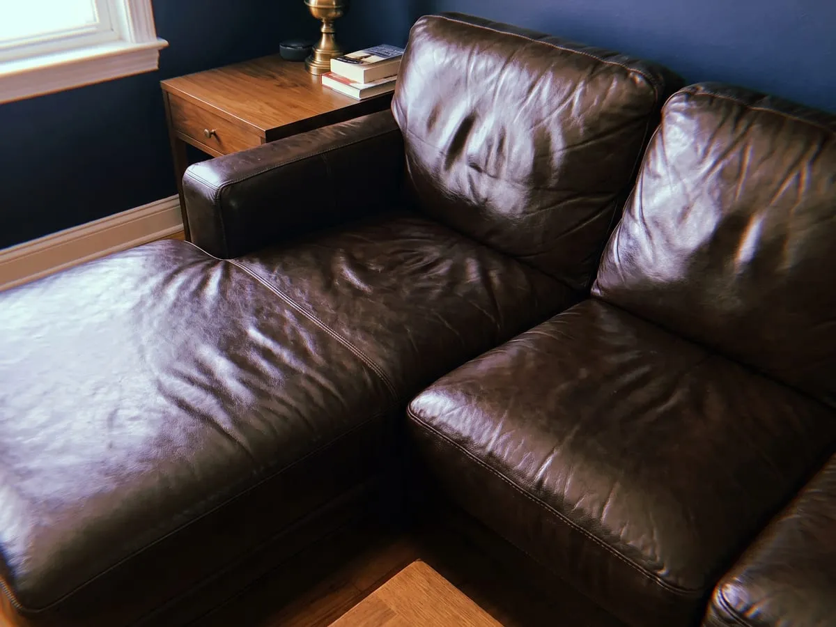 Black leather sofa before and after cleaning and conditioning