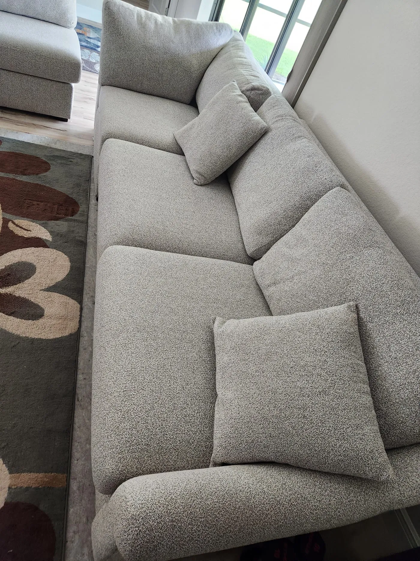 Grey boucle sofa with cushions restored after cleaning