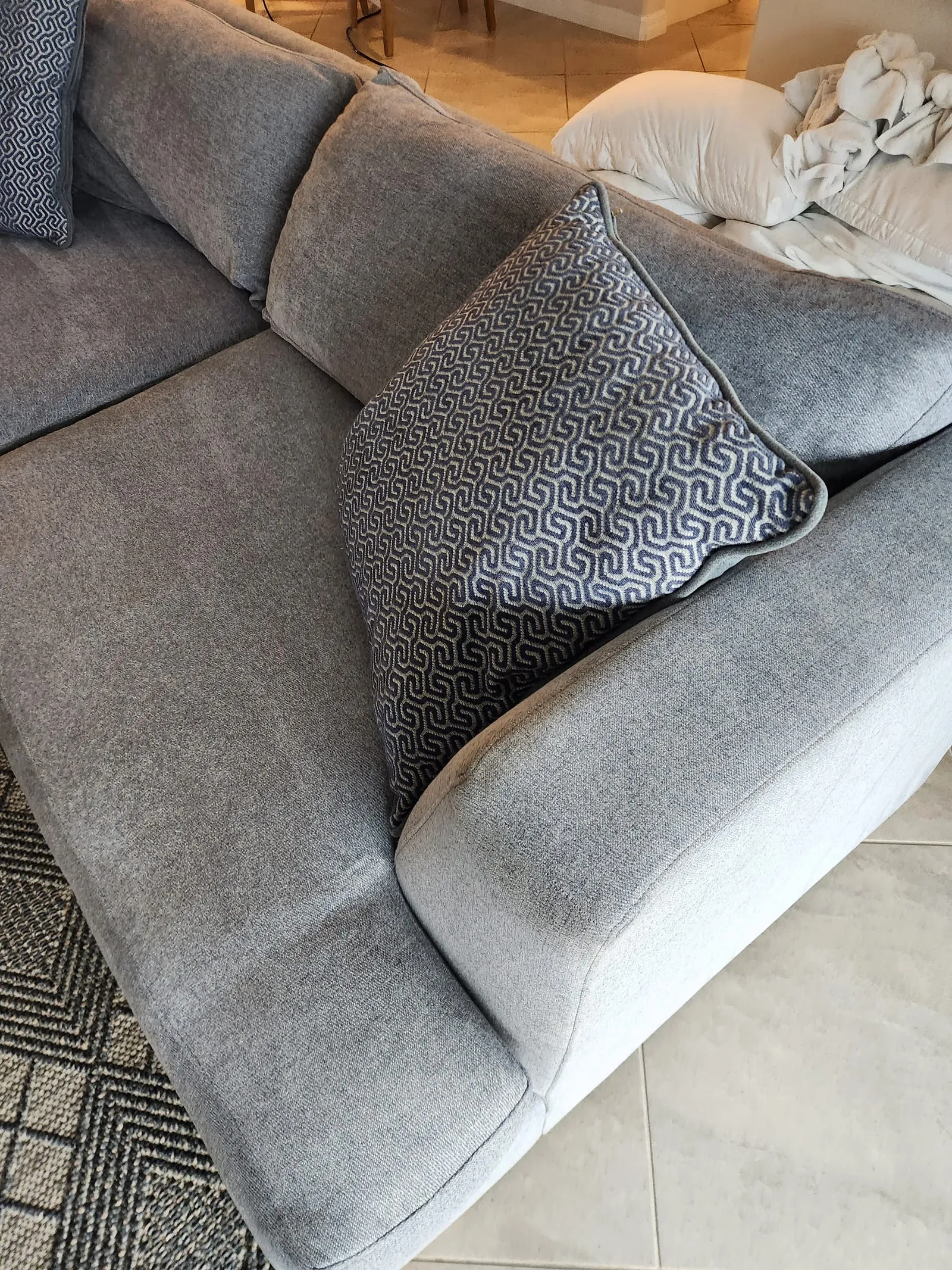 Grey upholstered sofa with restored texture
